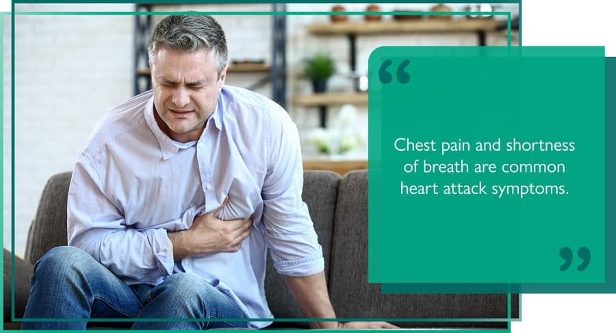 Person clasping their chest after experiencing heart-attack symptoms
